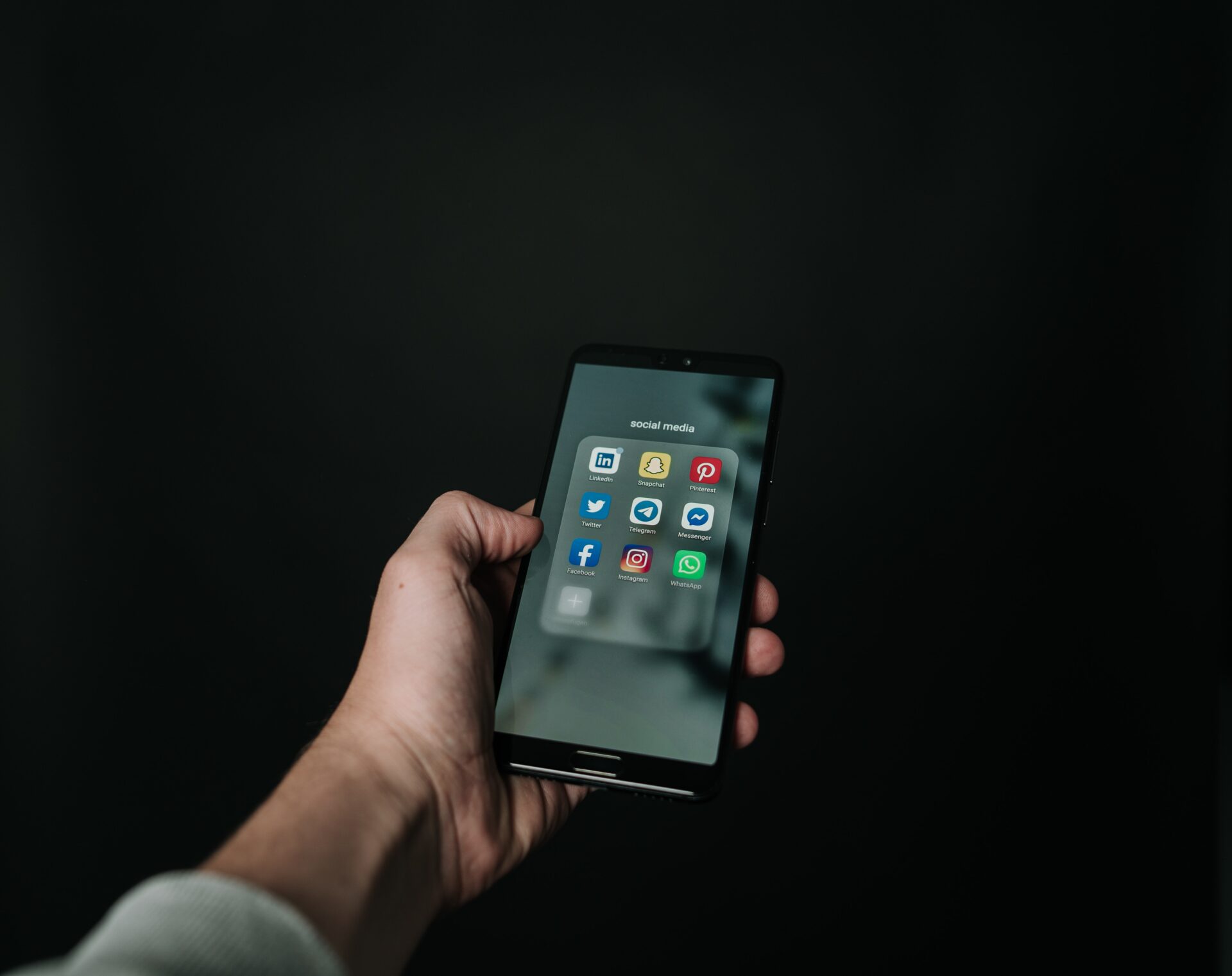 A man holding the mobile phone inside of social media apps